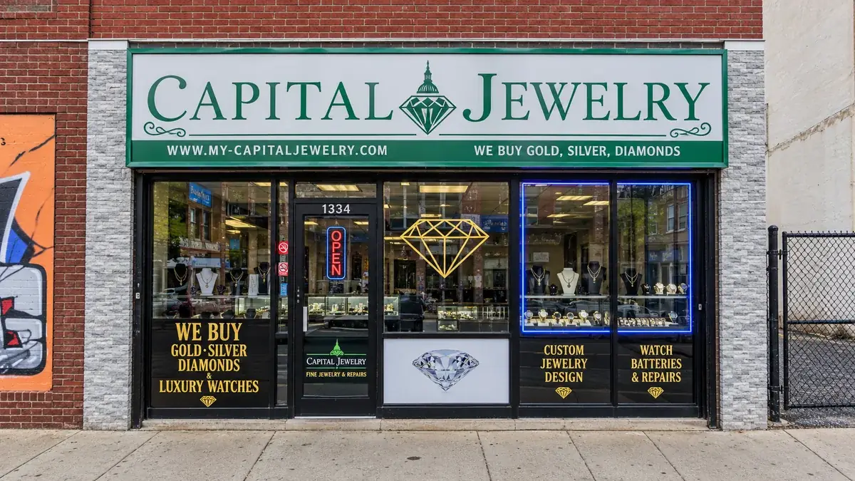 Capital Jewelry storefront with a green and white sign above display windows full of gold necklaces and rings