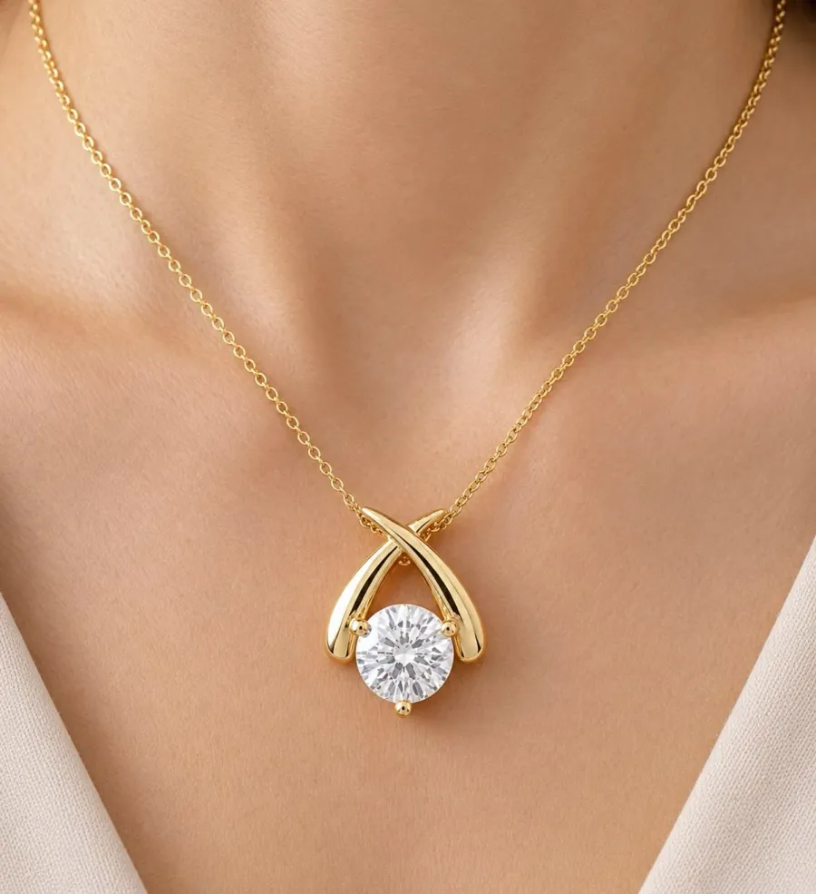 Yellow gold crossover pendant with a round solitaire stone on a fine cable chain