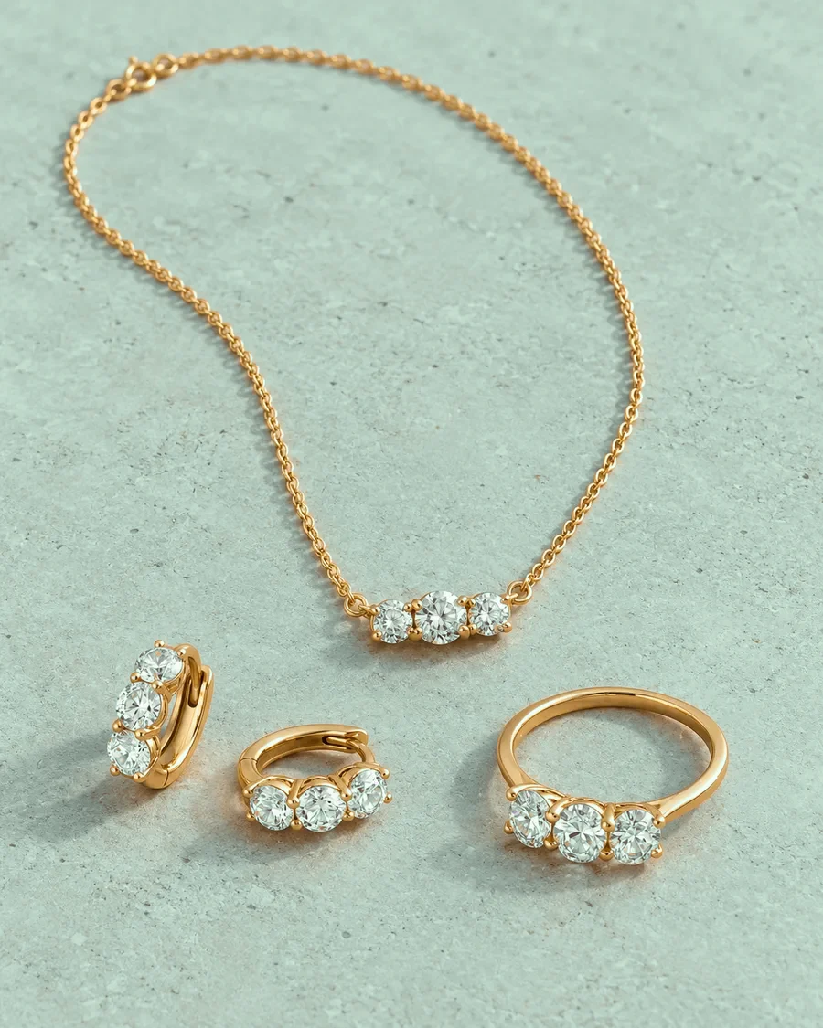 Gold diamond jewelry set laid out for cleaning